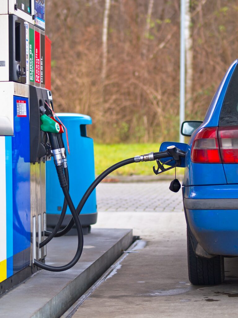 Blue car at gas station